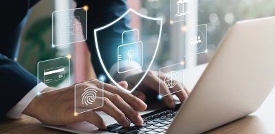 Person typing on laptop with hologram of privacy to protect personal data, lock icon and internet network security connection technology.