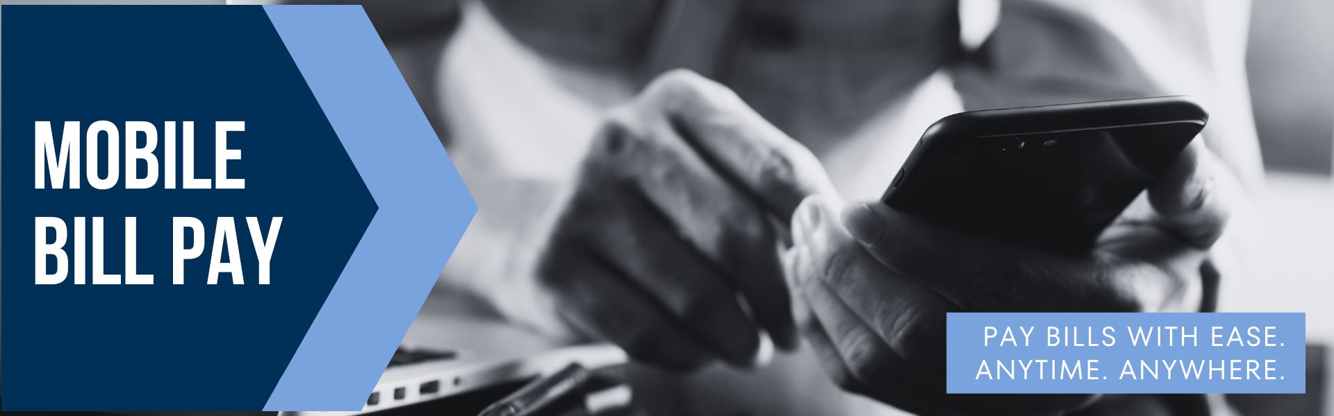 Hands holding a phone paying bills using mobile banking app.